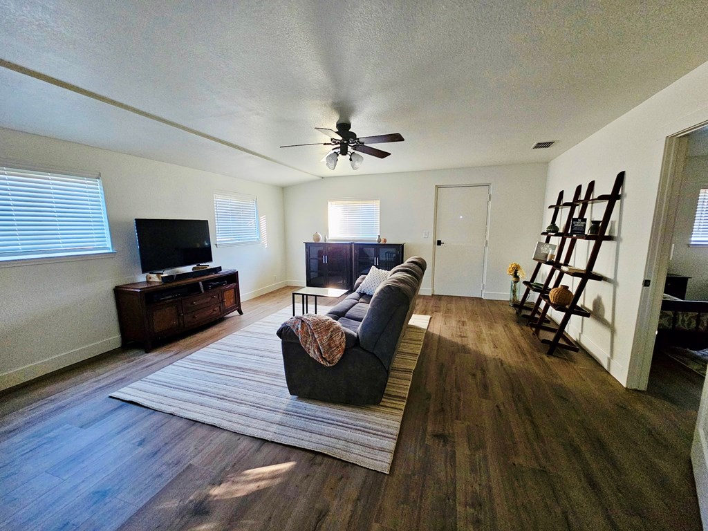 1031 Shin Oak Road, Unit 32 Menard, TX 76859 - Photo 9 of 23 a living room with furniture and a flat screen tv