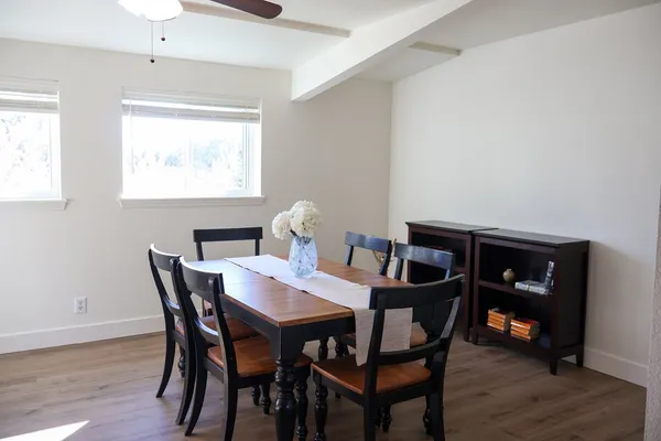 a view of a room with furniture and wooden floor
