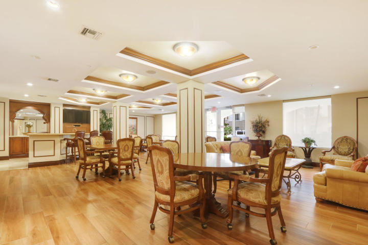 4207 Renaissance Way, Unit 207 Boynton Beach, FL 33426 - Photo 17 of 21 a view of a dining room with furniture window and wooden floor
