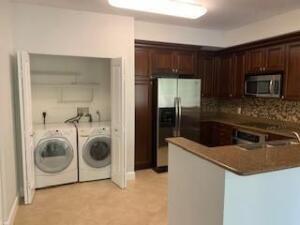 4207 Renaissance Way, Unit 207 Boynton Beach, FL 33426 - Photo 5 of 21 a kitchen with a refrigerator and washer