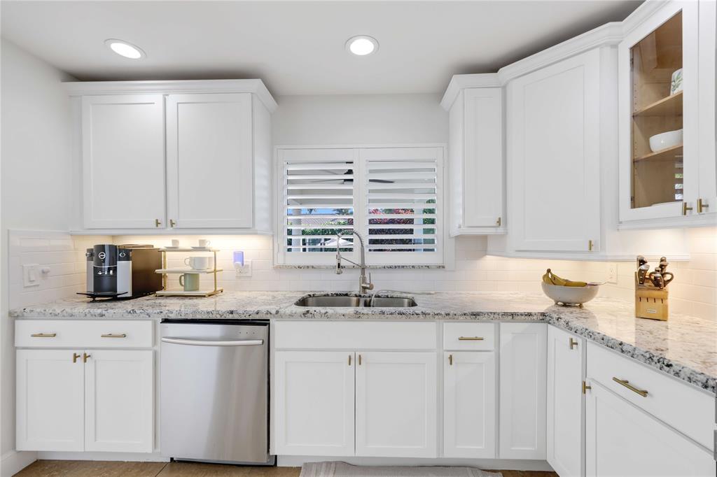 491 Northwest 13th Drive Boca Raton, FL 33486 - Photo 18 of 48 a kitchen with granite countertop white cabinets white appliances and a sink