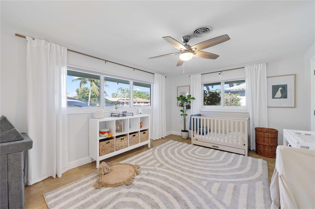 491 Northwest 13th Drive Boca Raton, FL 33486 - Photo 25 of 48 a bedroom with a bed and a window