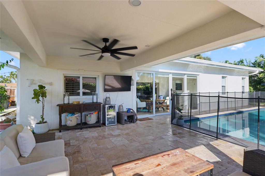 491 Northwest 13th Drive Boca Raton, FL 33486 - Photo 33 of 48 a living room with furniture a flat screen tv and a large window