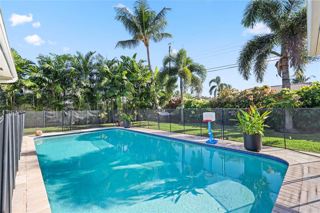 491 Northwest 13th Drive Boca Raton, FL 33486 - Photo 34 of 48 a view of swimming pool with a table and chairs
