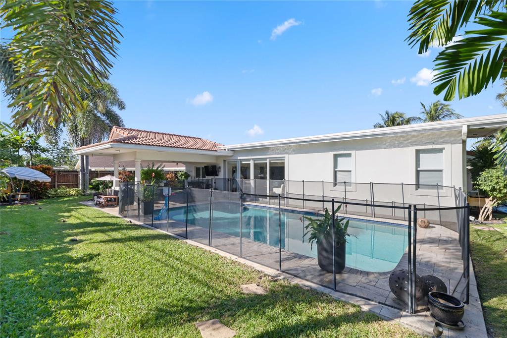 491 Northwest 13th Drive Boca Raton, FL 33486 - Photo 39 of 48 a view of a backyard with plants and a patio