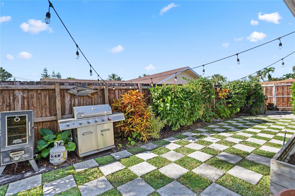 491 Northwest 13th Drive Boca Raton, FL 33486 - Photo 42 of 48 a view of a patio with table and chairs and potted plants