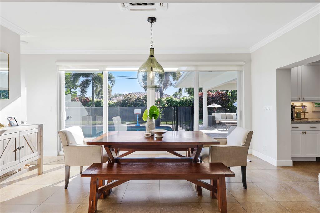 491 Northwest 13th Drive Boca Raton, FL 33486 - Photo 5 of 48 a dining room with furniture a chandelier and wooden floor