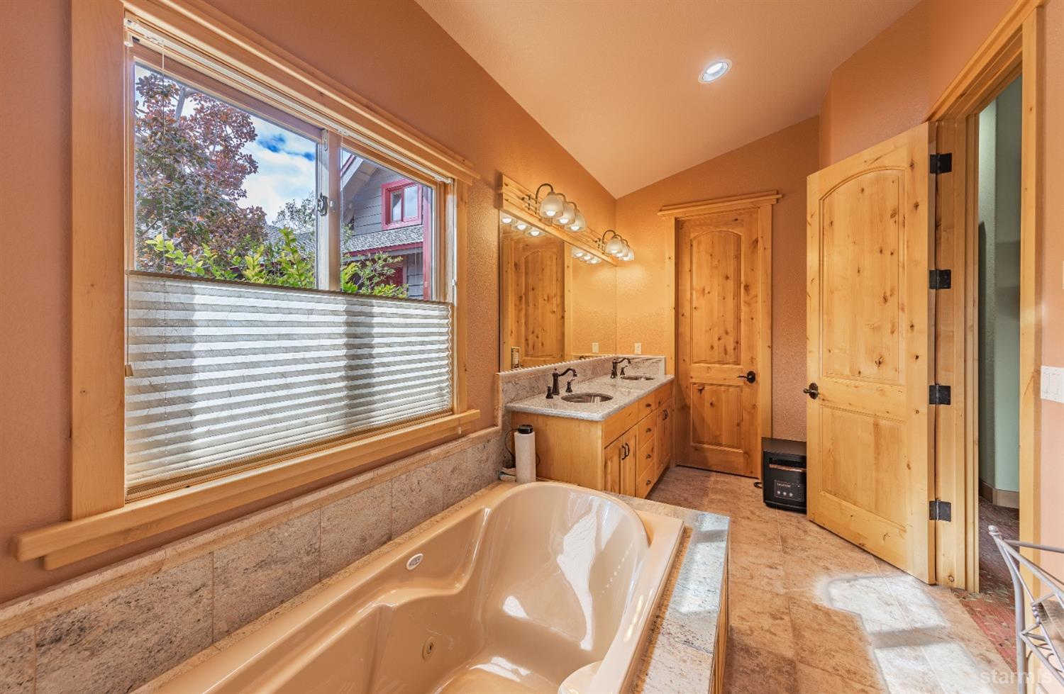 355 River Ranch Road Markleeville, CA 96120 - Photo 15 of 36 a room with a bed and a chandelier