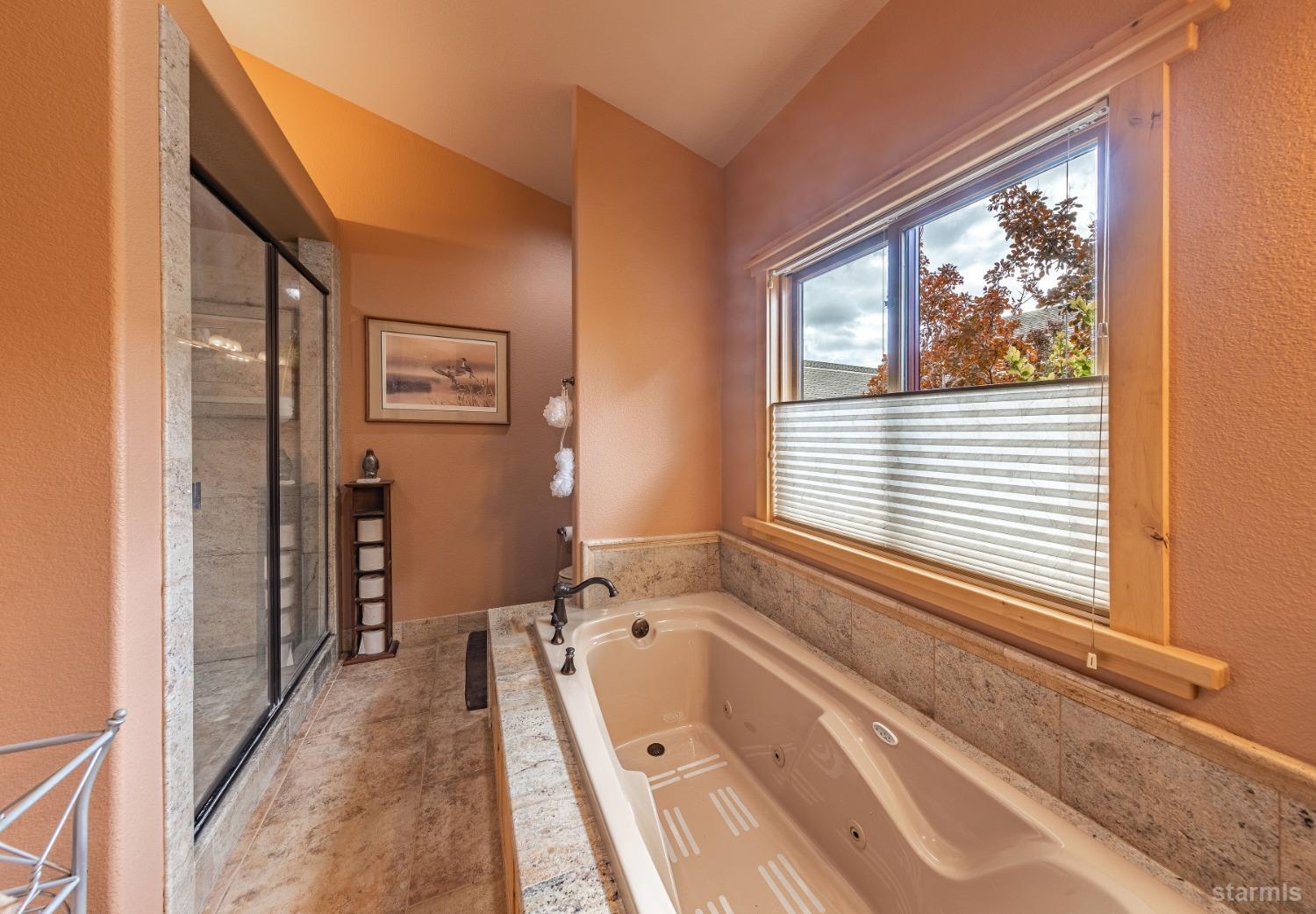 355 River Ranch Road Markleeville, CA 96120 - Photo 16 of 36 a bathroom with a tub and a large window