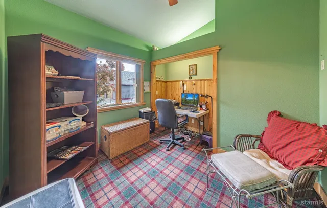 a living room with furniture a rug and a window