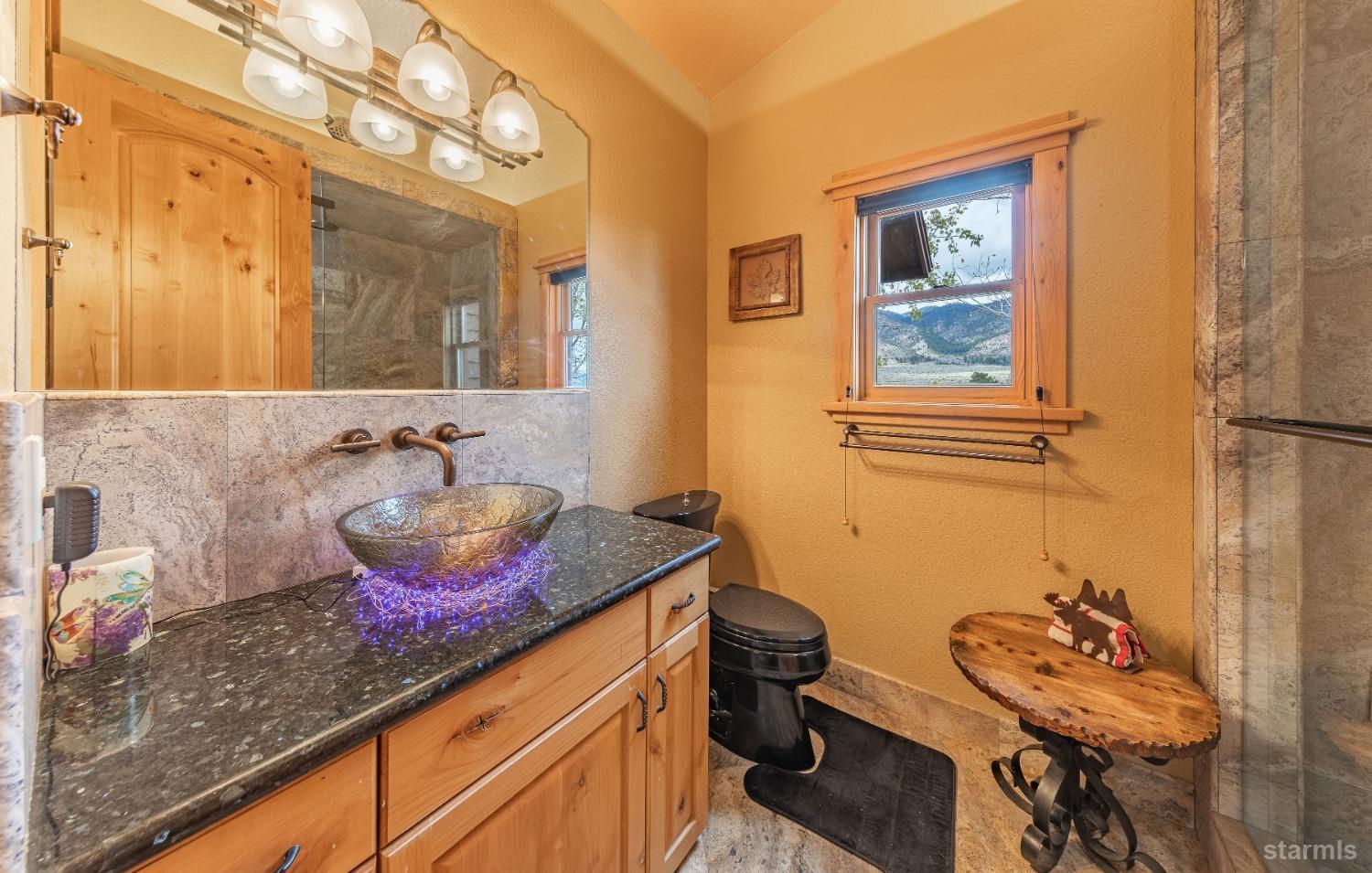 355 River Ranch Road Markleeville, CA 96120 - Photo 19 of 36 a bathroom with a granite countertop sink a mirror and a shower