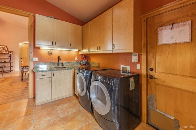 a utility room with sink dryer and washer