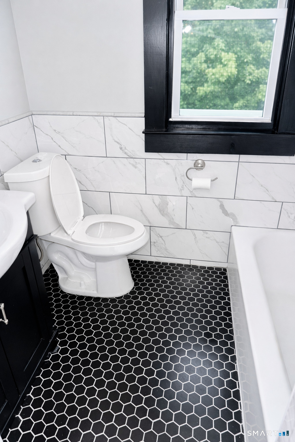 65 Wooding Street, Unit 3 Bristol, CT 06010 - Photo 5 of 8 a bathroom with a toilet a window and a shower