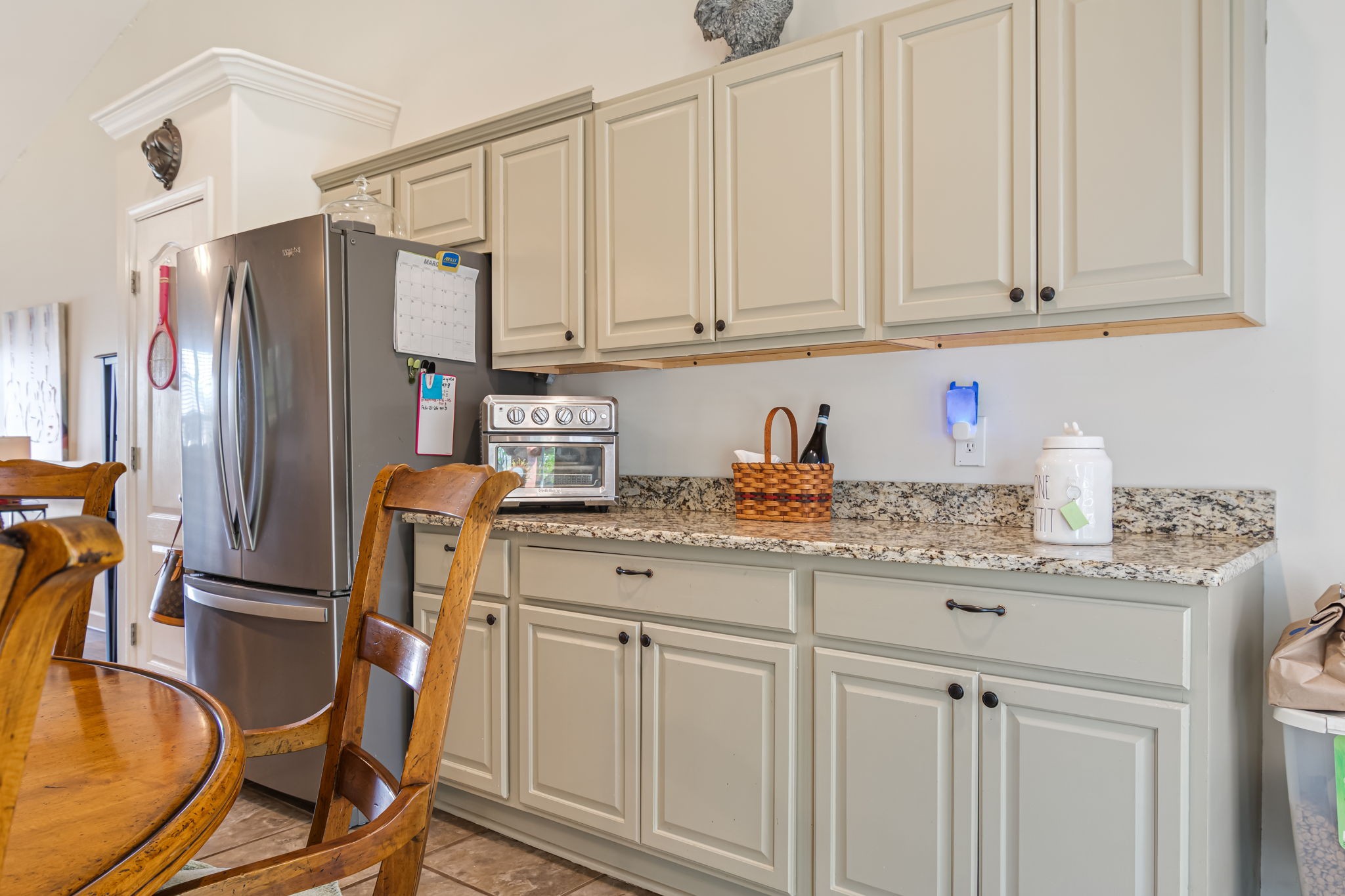 4989 Morning Dove Lane Spring Hill, TN 37174 - Photo 12 of 28 a kitchen with stainless steel appliances granite countertop a sink refrigerator and cabinets
