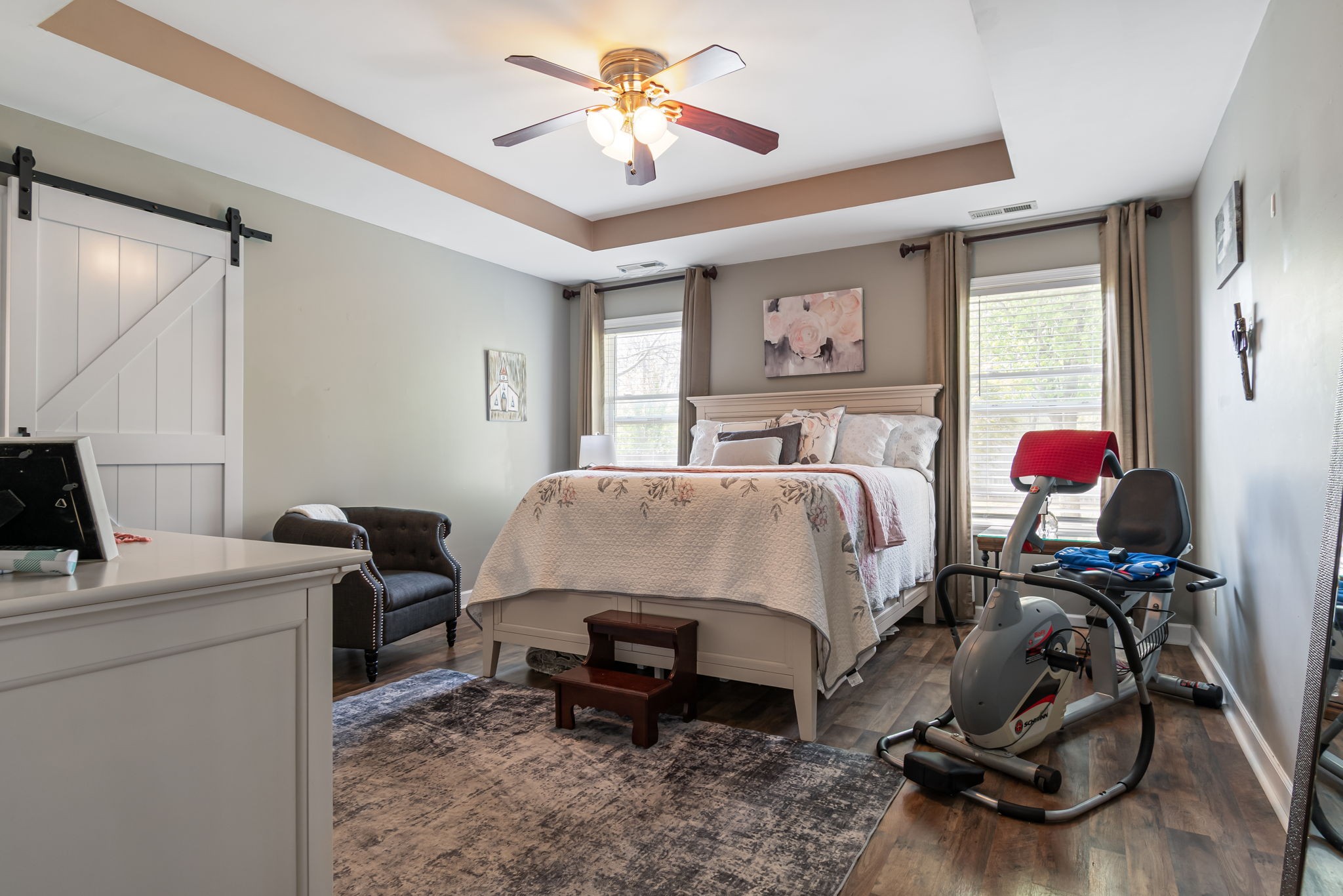4989 Morning Dove Lane Spring Hill, TN 37174 - Photo 15 of 28 a bedroom with a bed and a chandelier