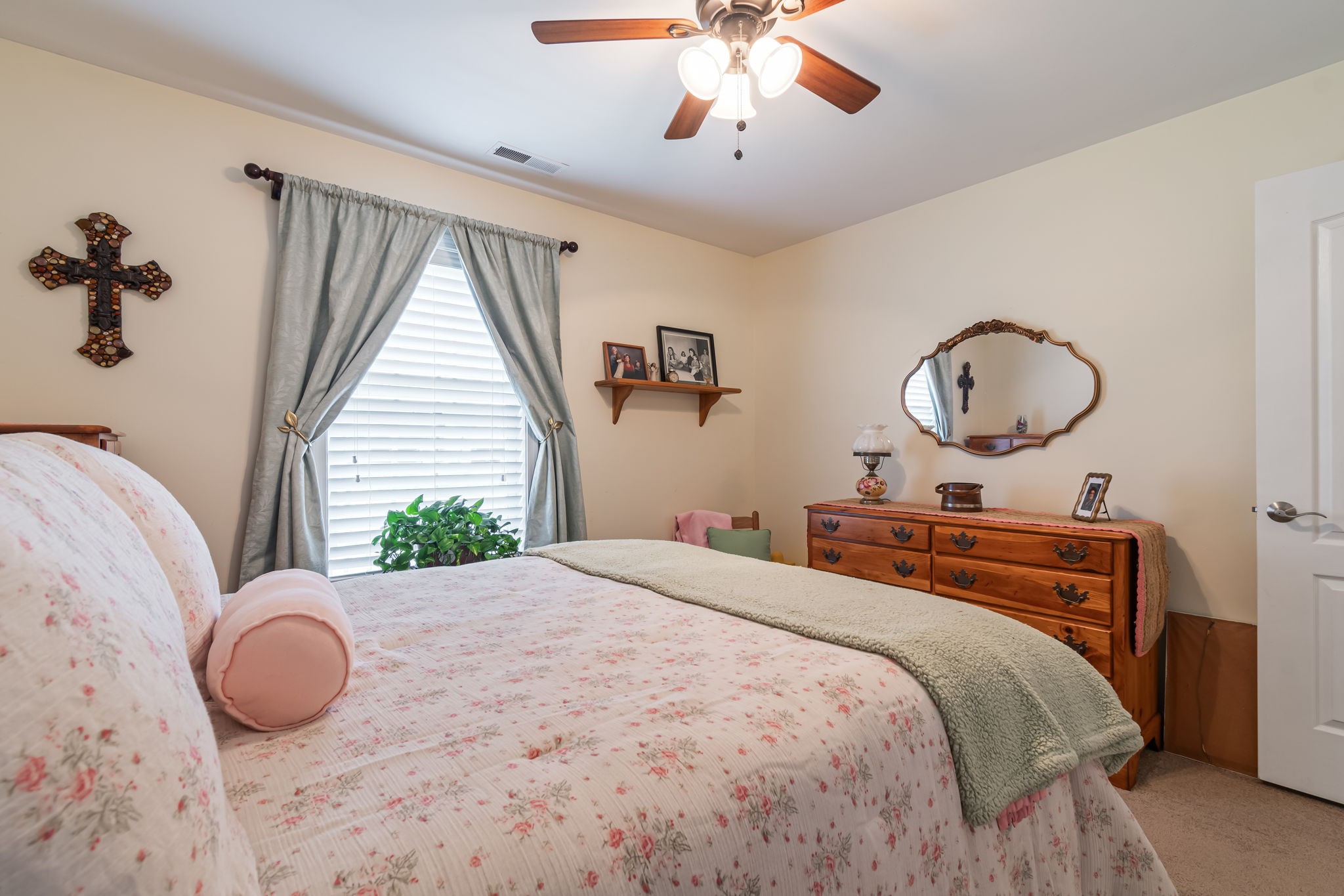 4989 Morning Dove Lane Spring Hill, TN 37174 - Photo 18 of 28 a bedroom with a large bed and a chandelier