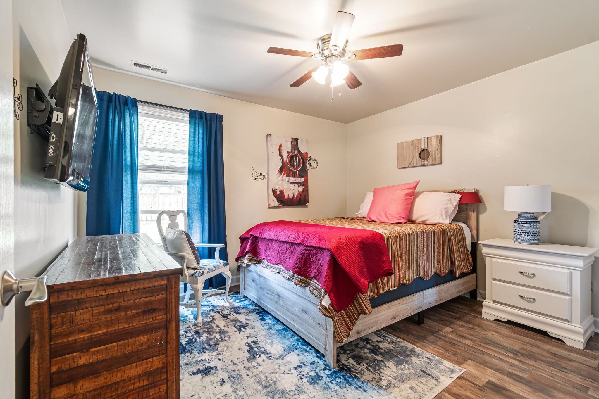 4989 Morning Dove Lane Spring Hill, TN 37174 - Photo 20 of 28 a spacious bedroom with a bed and a chandelier