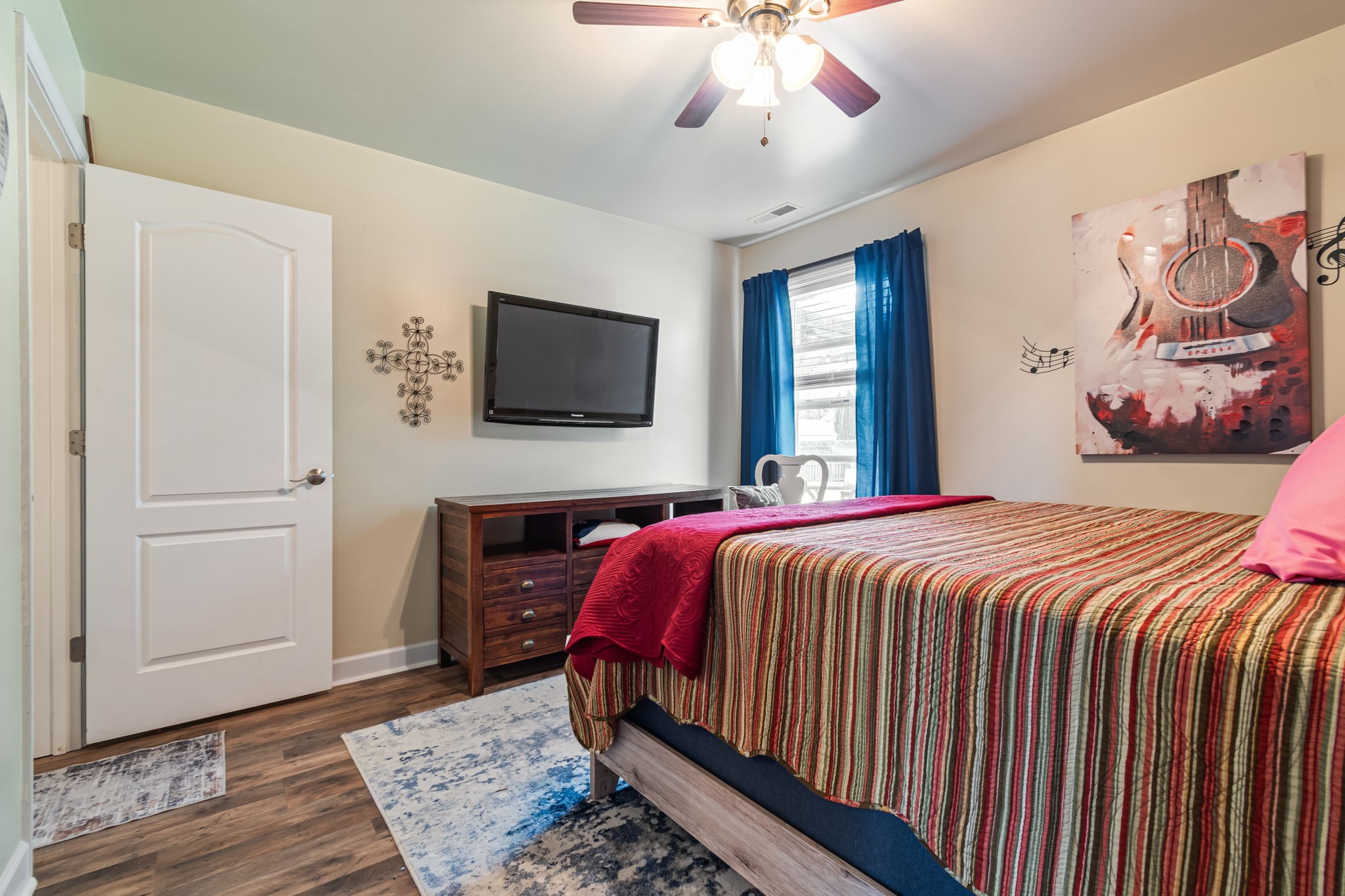 4989 Morning Dove Lane Spring Hill, TN 37174 - Photo 21 of 28 a bedroom with a bed and a flat screen tv