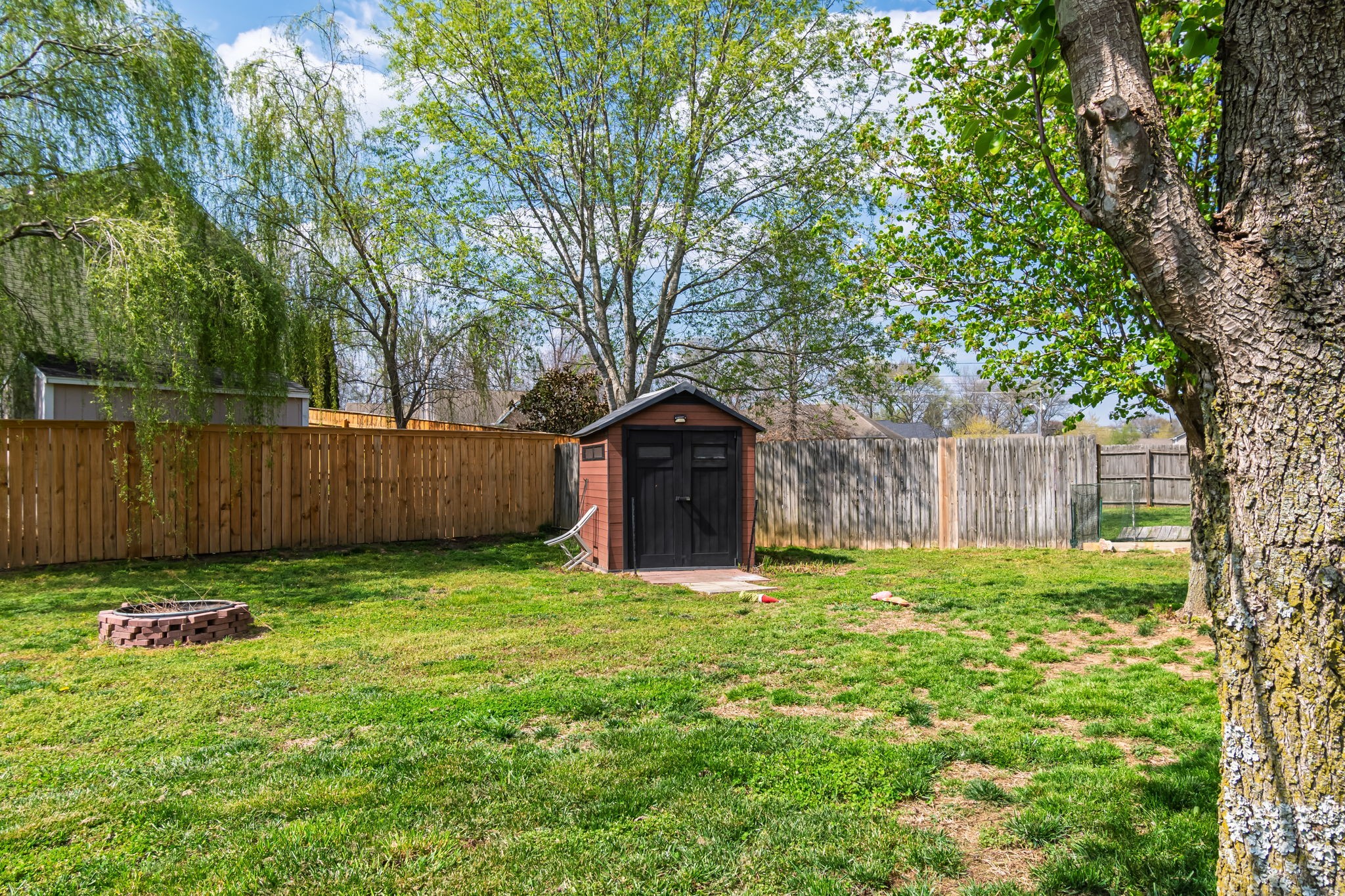 4989 Morning Dove Lane Spring Hill, TN 37174 - Photo 27 of 28 a big yard with large trees and wooden fence