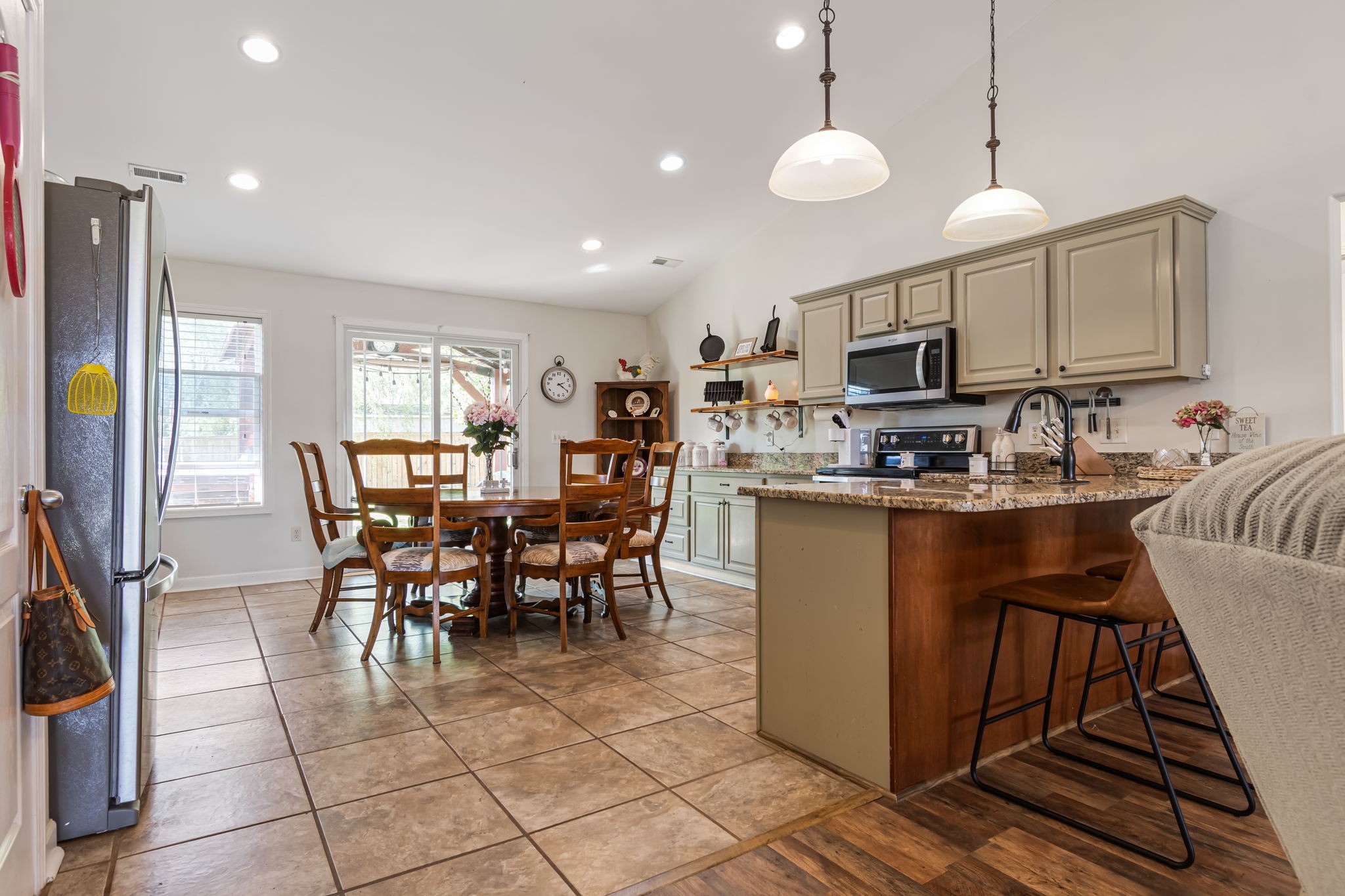 4989 Morning Dove Lane Spring Hill, TN 37174 - Photo 10 of 28 a kitchen with kitchen island granite countertop a sink a counter top space appliances and cabinets