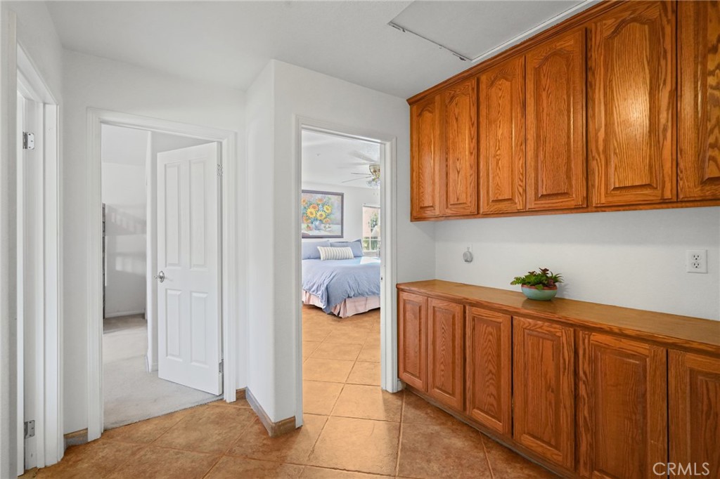 11709 Mint Canyon Road Agua Dulce, CA 91390 - Photo 11 of 49 a bedroom with a bed and wooden cabinets