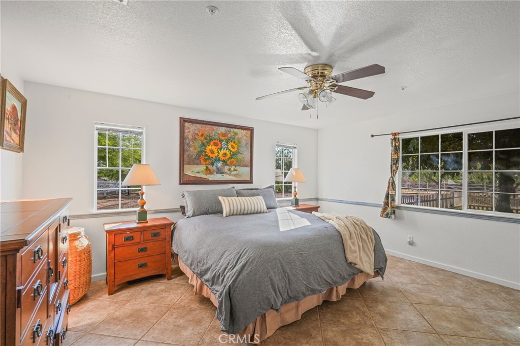 11709 Mint Canyon Road Agua Dulce, CA 91390 - Photo 12 of 49 a bedroom with a bed and a chandelier