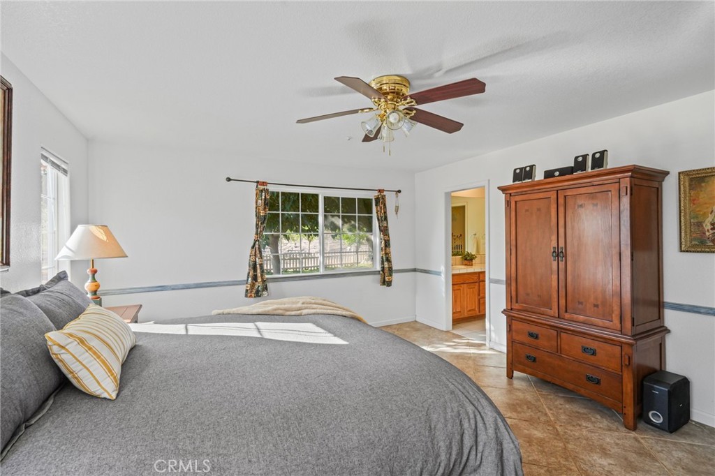 11709 Mint Canyon Road Agua Dulce, CA 91390 - Photo 13 of 49 a bedroom with a bed and a chandelier