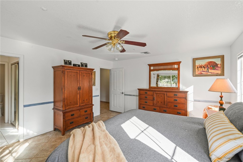11709 Mint Canyon Road Agua Dulce, CA 91390 - Photo 14 of 49 a bedroom with furniture and a chandelier