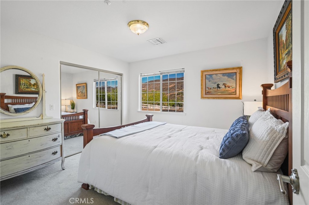 11709 Mint Canyon Road Agua Dulce, CA 91390 - Photo 17 of 49 a bedroom with a bed and a dresser next to a window