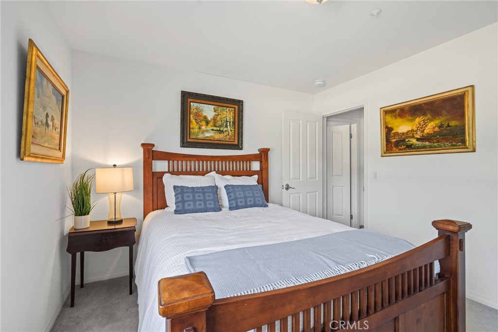 11709 Mint Canyon Road Agua Dulce, CA 91390 - Photo 18 of 49 a bedroom with a bed and a painting on the wall