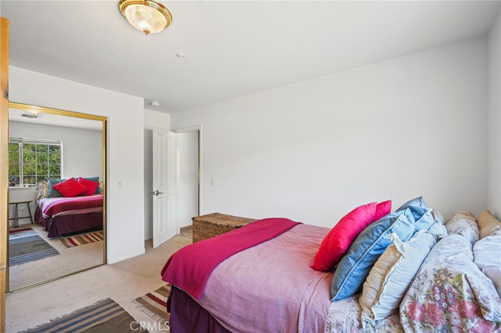 11709 Mint Canyon Road Agua Dulce, CA 91390 - Photo 21 of 49 a bedroom with a bed and a chandelier