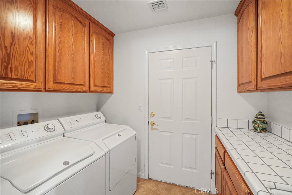 11709 Mint Canyon Road Agua Dulce, CA 91390 - Photo 26 of 49 a utility room with dryer and washer