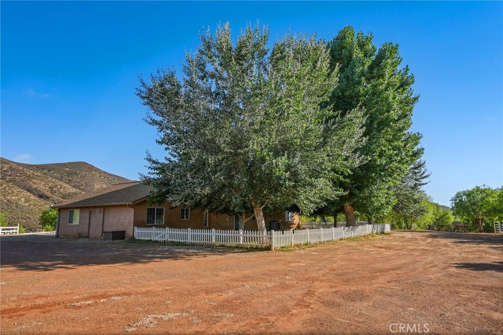 11709 Mint Canyon Road Agua Dulce, CA 91390 - Photo 30 of 49 a view of a yard with a house in the background