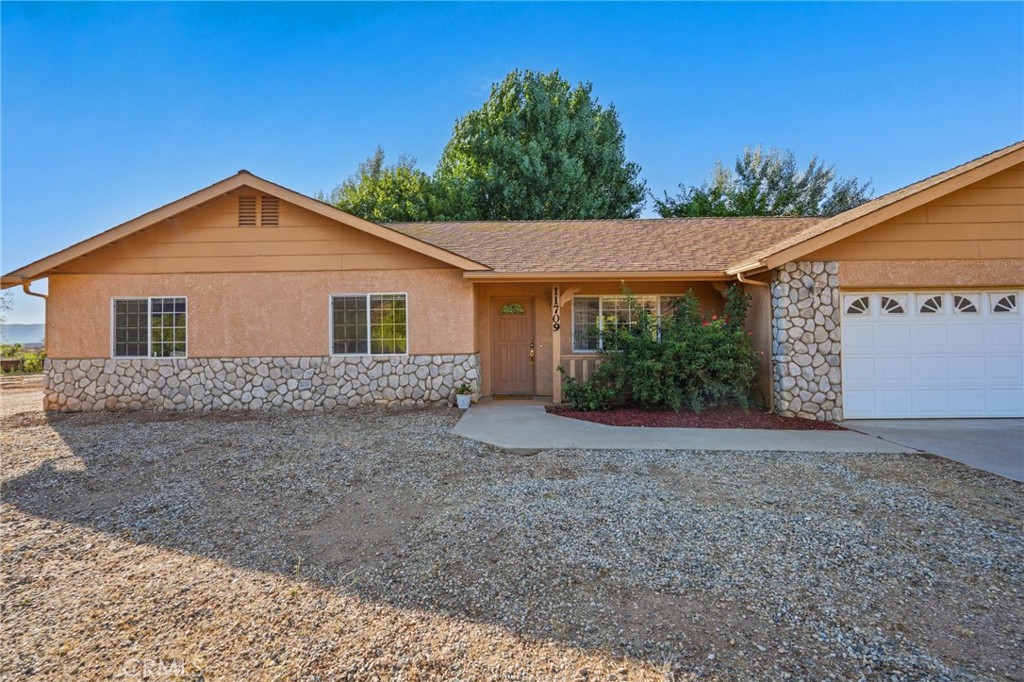 11709 Mint Canyon Road Agua Dulce, CA 91390 - Photo 47 of 49 a view of a house with a yard and potted plants
