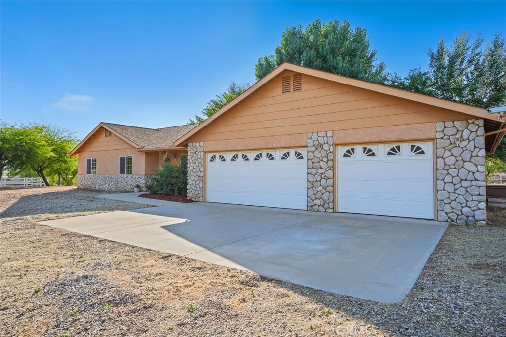 11709 Mint Canyon Road Agua Dulce, CA 91390 - Photo 5 of 49 a front view of a house with a yard and garage