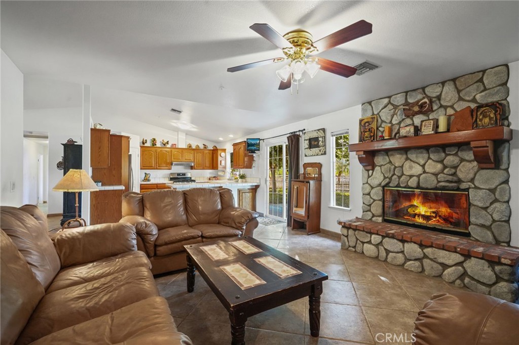 11709 Mint Canyon Road Agua Dulce, CA 91390 - Photo 6 of 49 a living room with furniture a flat screen tv and a fireplace