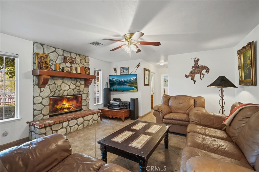 11709 Mint Canyon Road Agua Dulce, CA 91390 - Photo 7 of 49 a living room with furniture a fireplace and a flat screen tv
