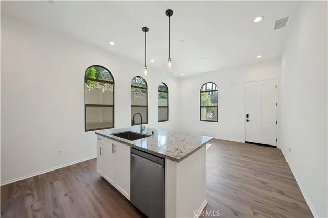 a bathroom with a toilet a sink a mirror a bathtub and vanity