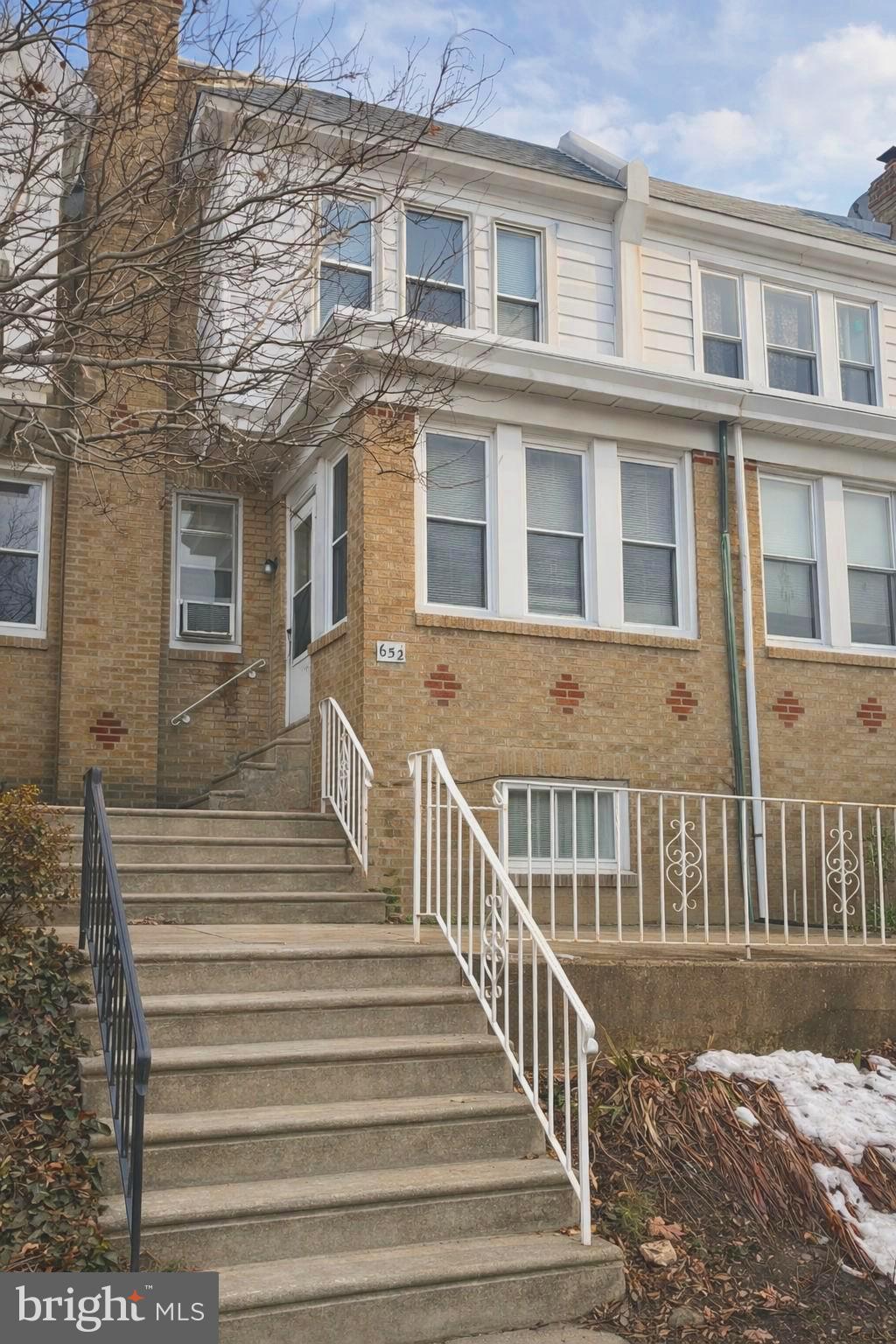 652 Jamestown Avenue Philadelphia, PA 19128 - Photo 1 of 13 a view of a brick building next to a yard
