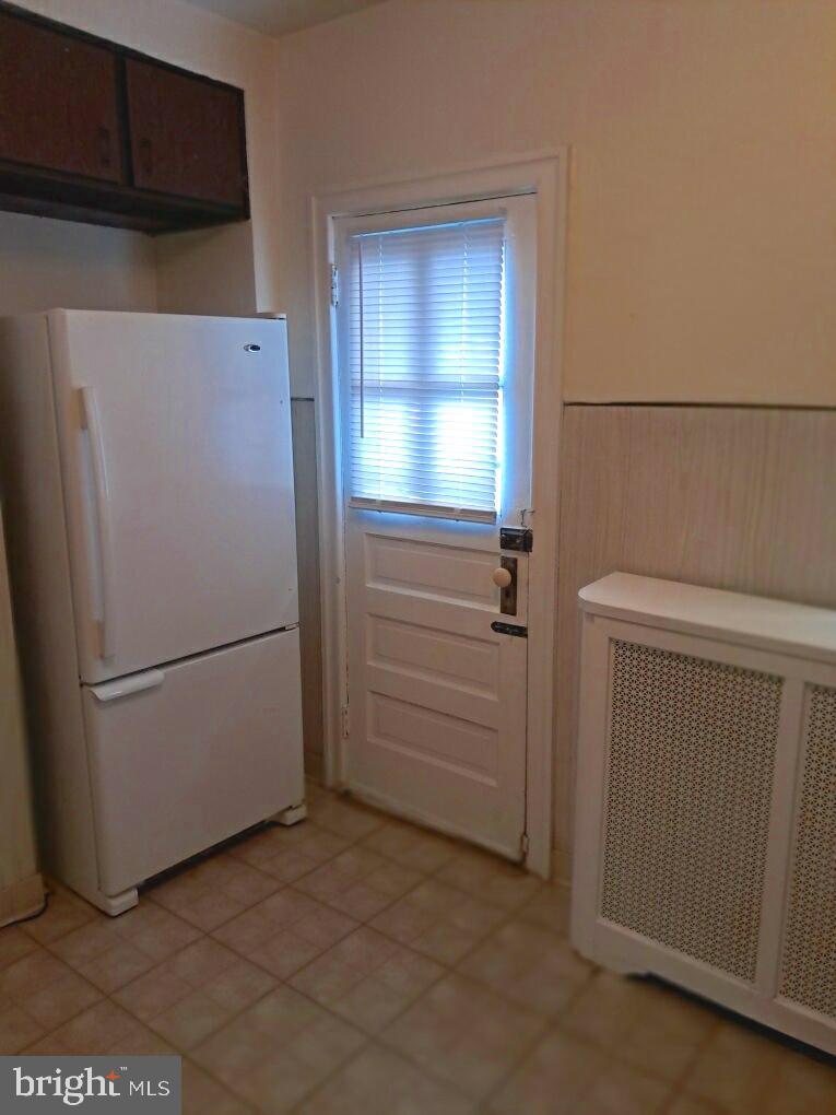 652 Jamestown Avenue Philadelphia, PA 19128 - Photo 13 of 13 a white refrigerator freezer and a stove sitting in a kitchen
