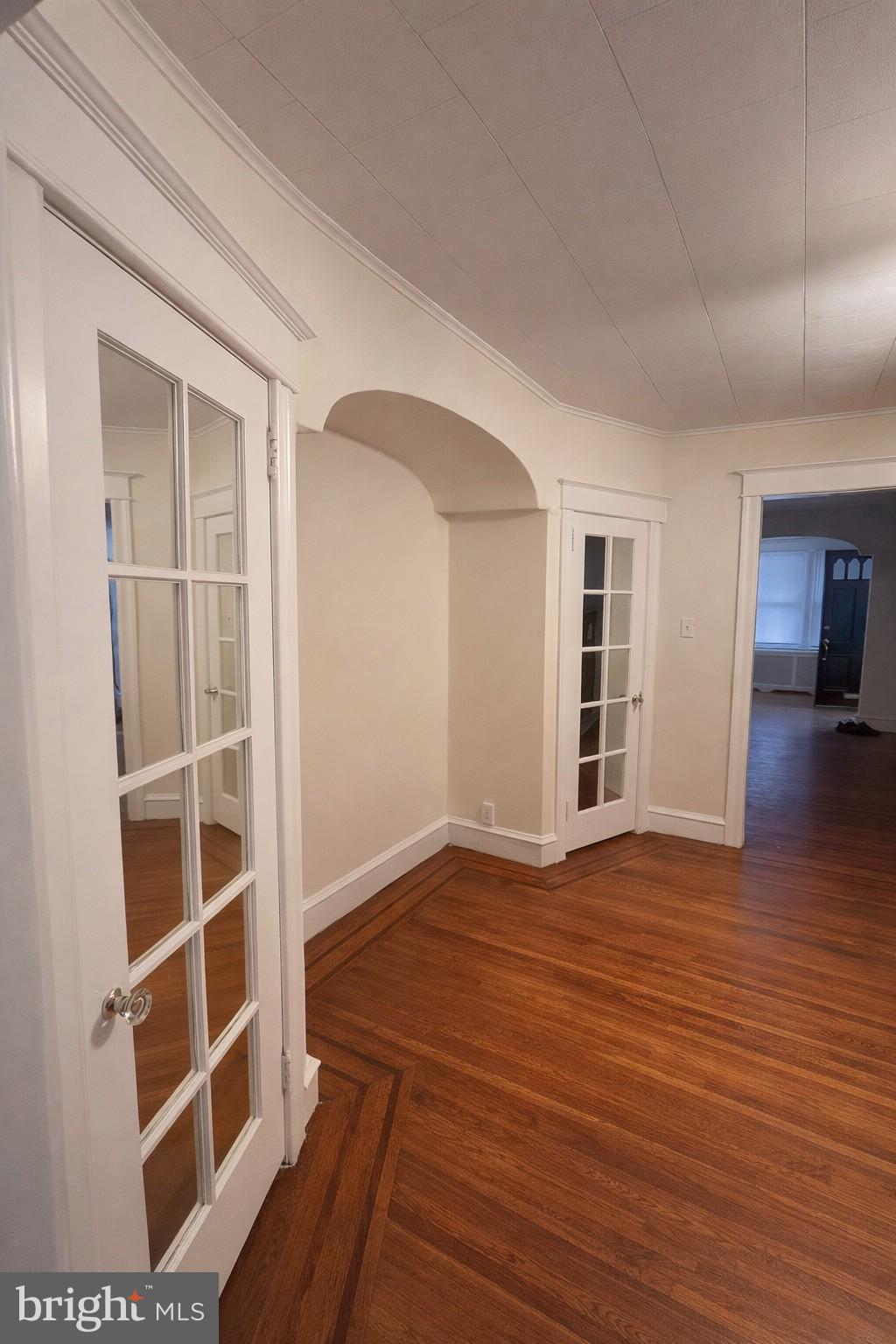 652 Jamestown Avenue Philadelphia, PA 19128 - Photo 4 of 13 a view of an empty room with wooden floor and a window