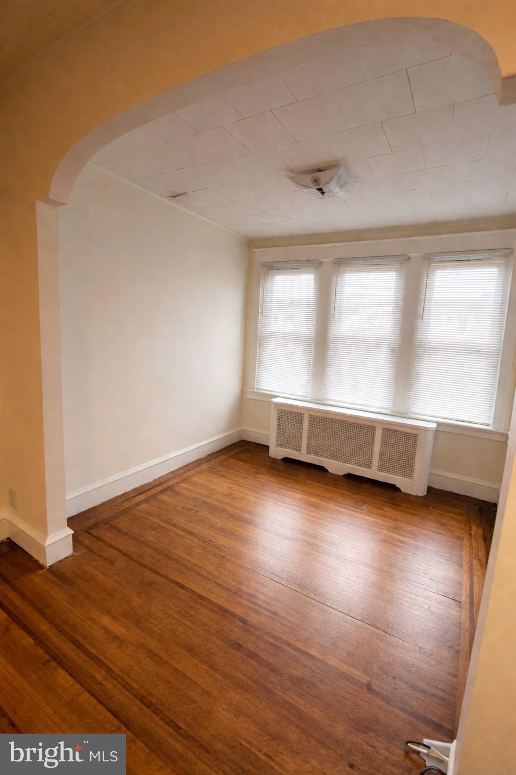 652 Jamestown Avenue Philadelphia, PA 19128 - Photo 5 of 13 an empty room with wooden floor and windows