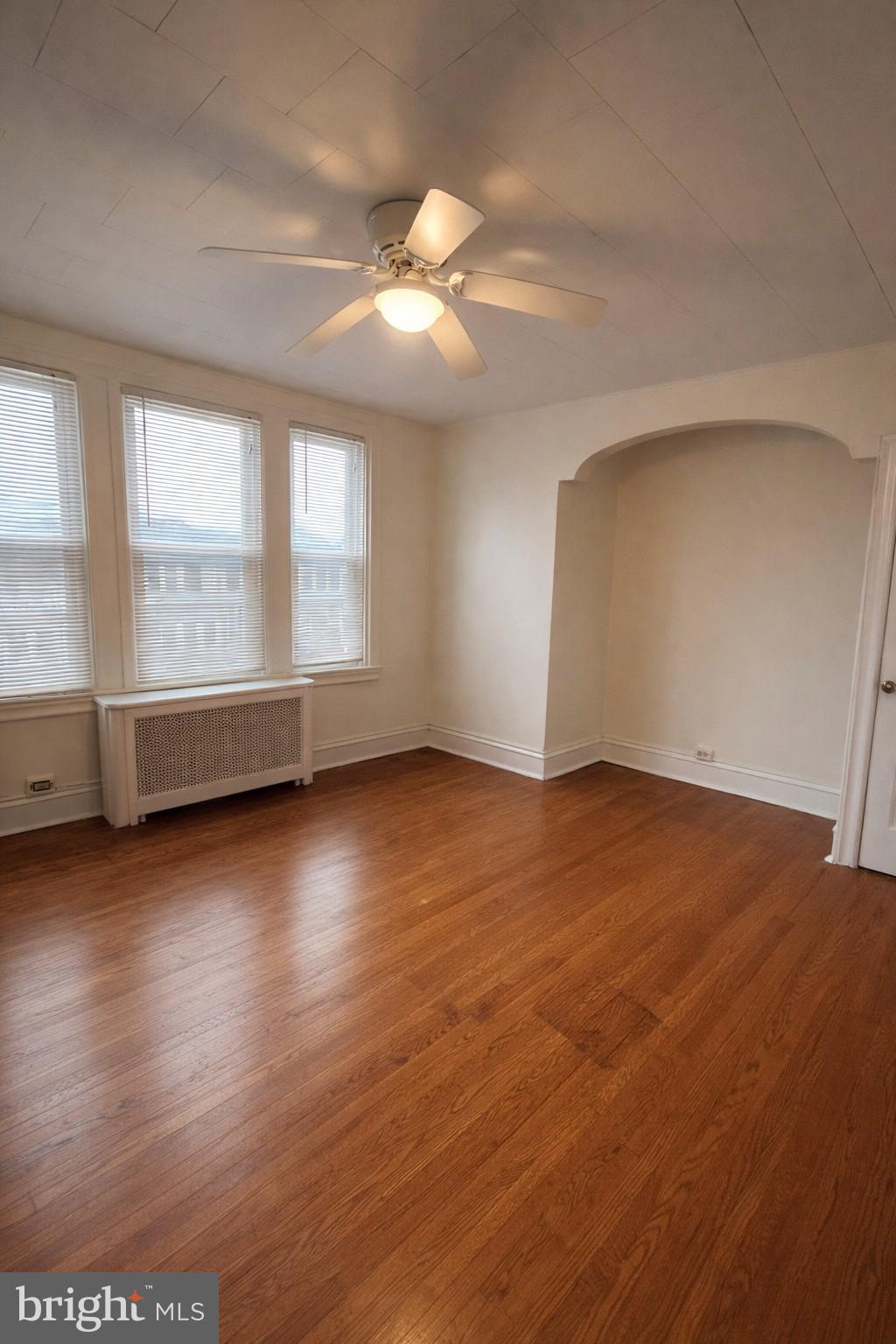 652 Jamestown Avenue Philadelphia, PA 19128 - Photo 7 of 13 an empty room with wooden floor and windows
