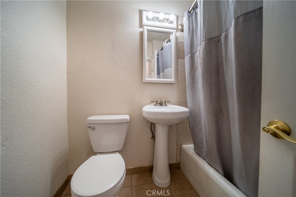 500 South Clymar Avenue Compton, CA 90220 - Photo 12 of 20 a white toilet sitting next to a bathroom sink