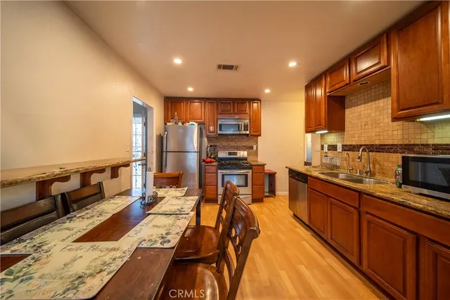 a large kitchen with lots of counter space and stainless steel appliances