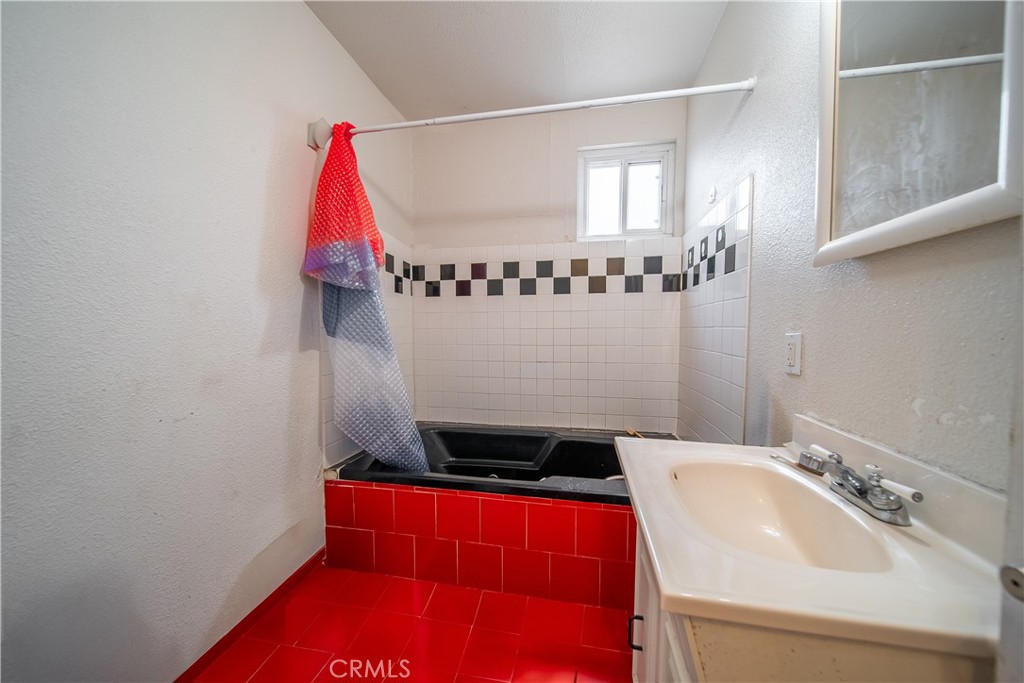 500 South Clymar Avenue Compton, CA 90220 - Photo 9 of 20 a bathroom with a sink and a mirror