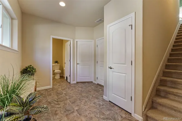 a kitchen with stainless steel appliances a refrigerator a table and chairs