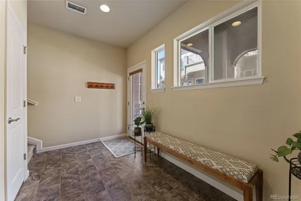 a bathroom with a granite countertop sink toilet and mirror