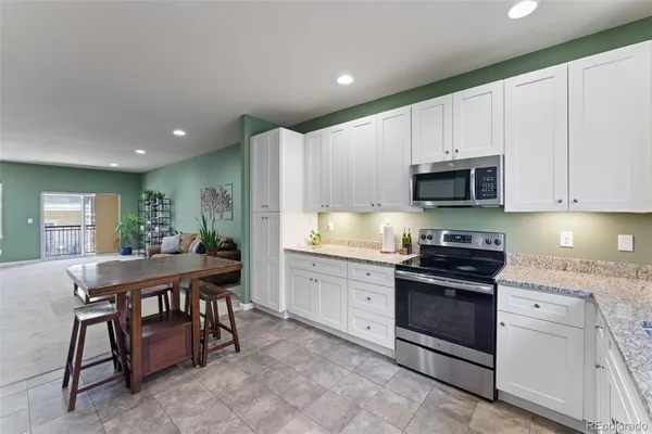 a kitchen with a table and chairs in it