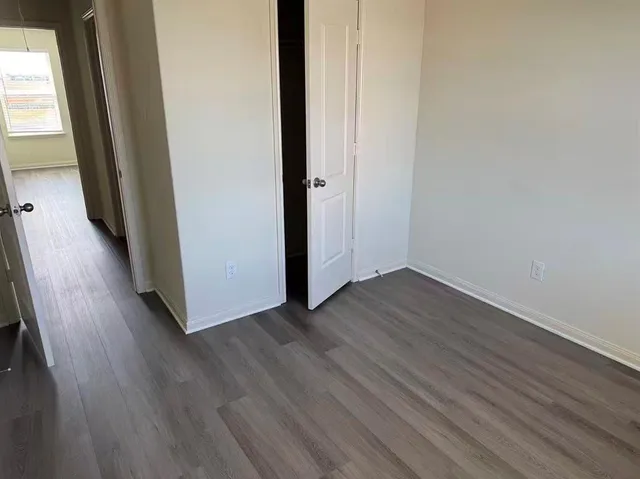 a view of a hallway with wooden floor